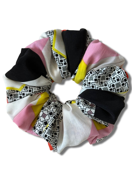 Colorful scrunchie with geometric patterns on a white background