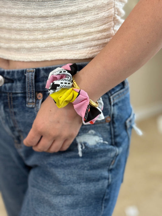 model wearing confetti crush XS scrunchie on wrist