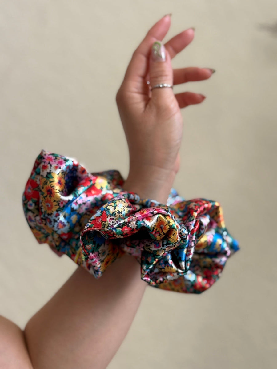 Wildflower satin floral scrunchie with a bold multicolor floral print, designed for thick and long hair, offering a secure and stylish wear.