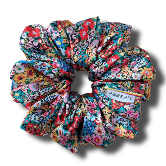Colorful floral scrunchie with 'Jasmine Jade' label on a white background
