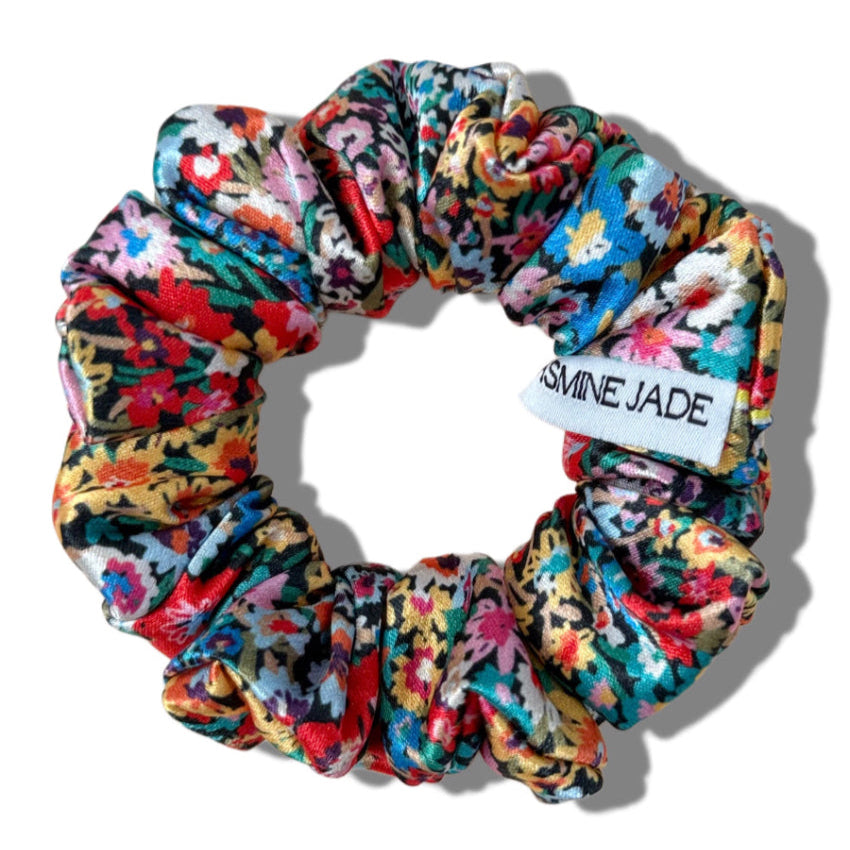 Multicolored floral scrunchie with 'Jasmine Jade' label on a white background